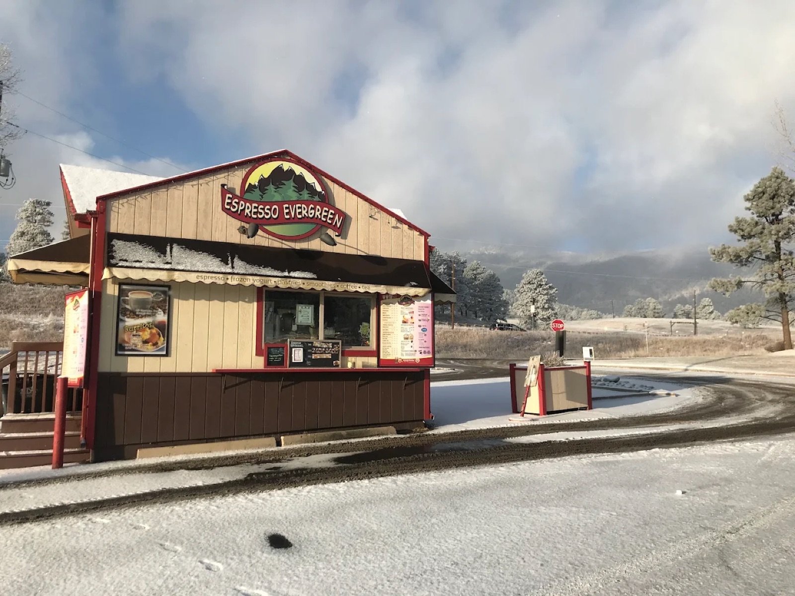 Espresso Evergreen before the rebrand: a tan and dark brown A-frame hut with red trim and a faded painted sign.